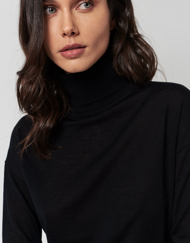 Black fine knit sweater with turtleneck.