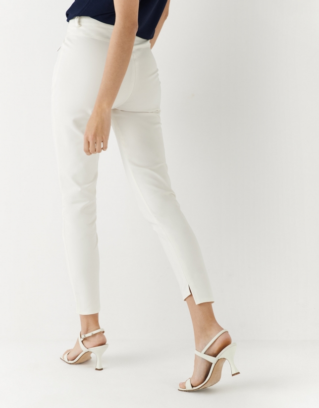 Beige colored fitted pants with zippered pockets