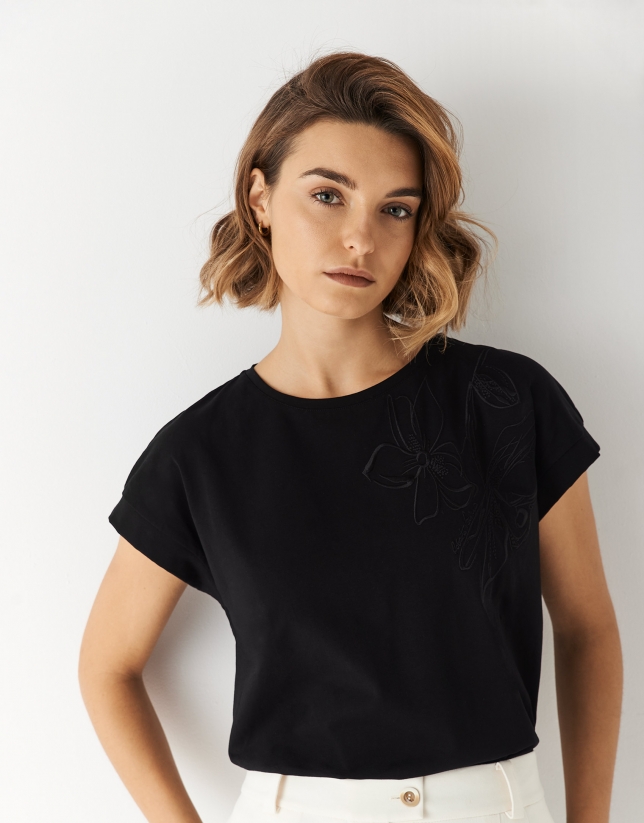 Black oversize sleeveless top with floral embroidery
