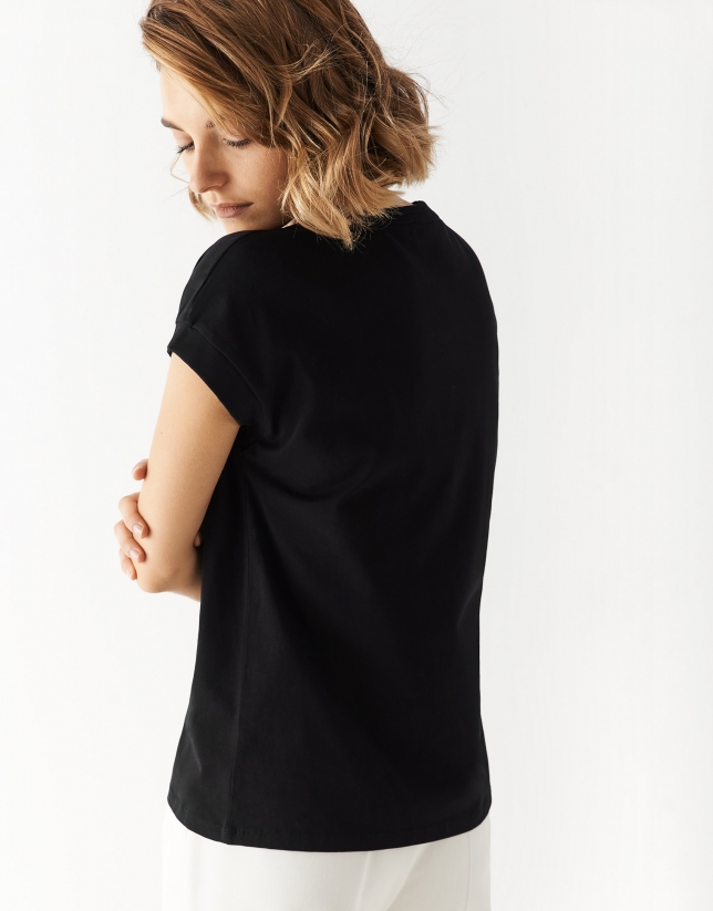 Black oversize sleeveless top with floral embroidery