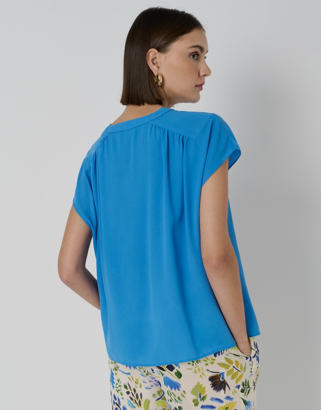 Blue blouse with gathered yoke on shoulders