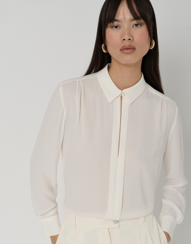 Beige blouse with front opening and pleat