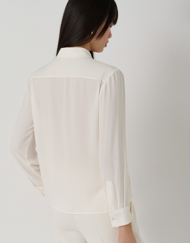 Beige blouse with front opening and pleat